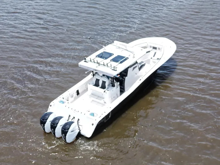  Yacht Photos Pics 2023 Tidewater 380 CC Adventure boat cruising on open water.