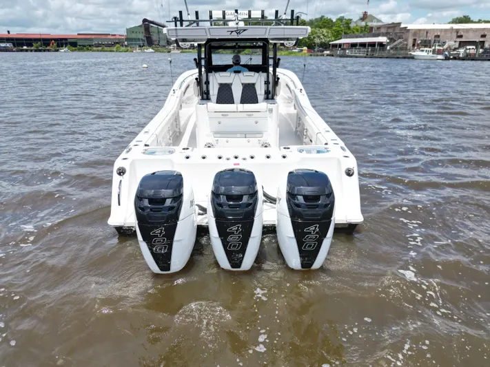  Yacht Photos Pics 2023 Tidewater 380 CC Adventure boat with triple 400 horsepower engines on water.