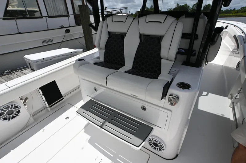  Yacht Photos Pics 2023 Tidewater 380 CC Adventure boat seating area with modern design and cup holders.