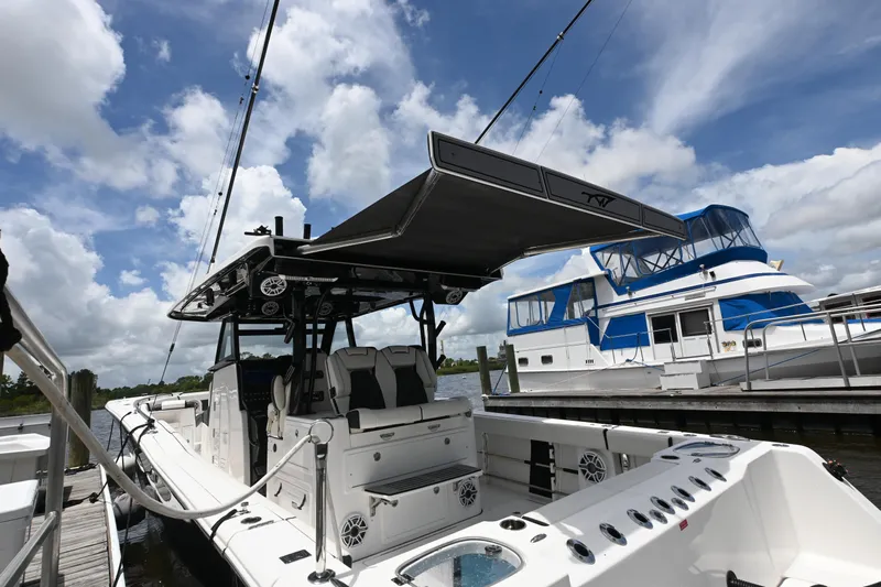  Yacht Photos Pics 2023 Tidewater 380 CC Adventure boat docked under a cloudy sky.