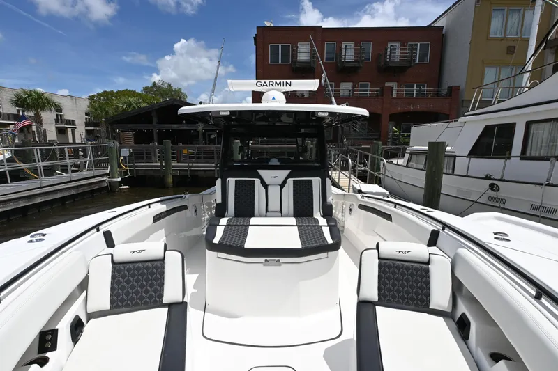  Yacht Photos Pics 2023 Tidewater 380 CC Adventure boat docked, featuring spacious seating and modern design.