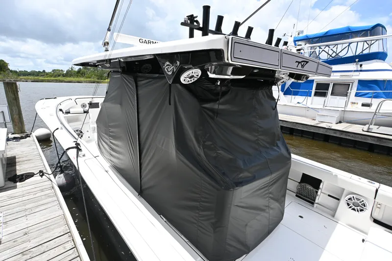  Yacht Photos Pics 2023 Tidewater 380 CC Adventure boat docked, featuring a covered console and sleek design.
