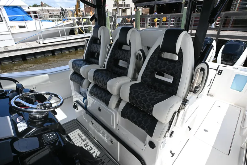  Yacht Photos Pics 2023 Tidewater 380 CC Adventure boat interior with luxury seating and steering wheel.
