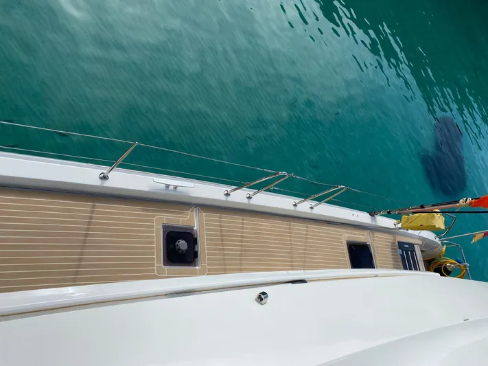 Slow Down Yacht Photos Pics 2023 Lagoon 55 yacht deck overlooking clear turquoise water.