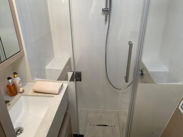 Slow Down Yacht Photos Pics Modern bathroom in 2023 Lagoon 55 yacht with shower and sink area.