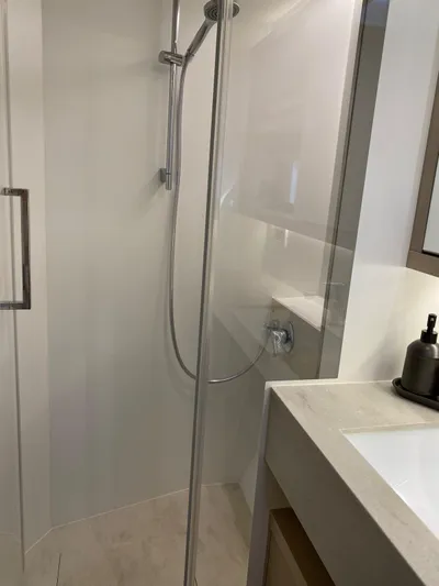 Slow Down Yacht Photos Pics Modern bathroom shower in 2023 Lagoon 55 yacht, featuring sleek design and fixtures.