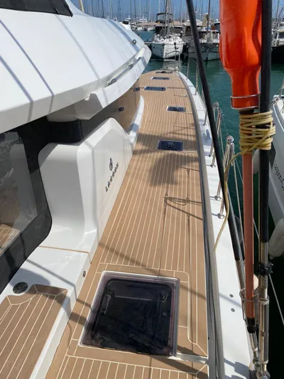 Slow Down Yacht Photos Pics 2023 Lagoon 55 yacht deck with sleek design and modern features in marina setting.