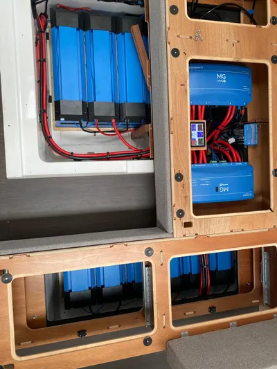 Slow Down Yacht Photos Pics Electrical system of a 2023 Lagoon 55 yacht, featuring blue battery units and wiring.