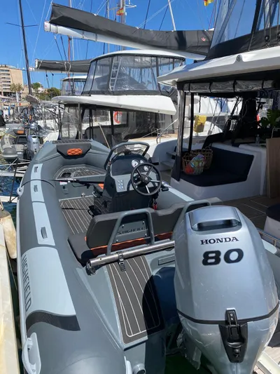 Slow Down Yacht Photos Pics 2023 Lagoon 55 yacht with Honda 80 engine docked at marina.