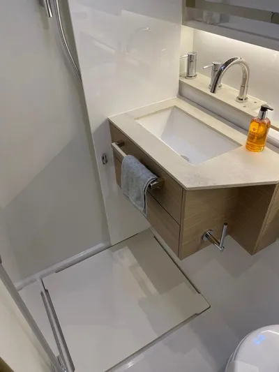 Slow Down Yacht Photos Pics Modern bathroom in 2023 Lagoon 55 yacht with sleek sink and fixtures.