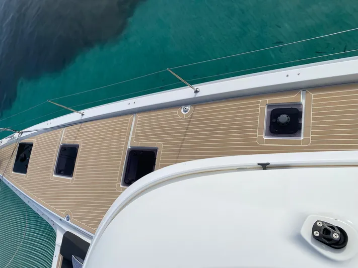 Slow Down Yacht Photos Pics Deck view of 2023 Lagoon 55 yacht with clear turquoise water.