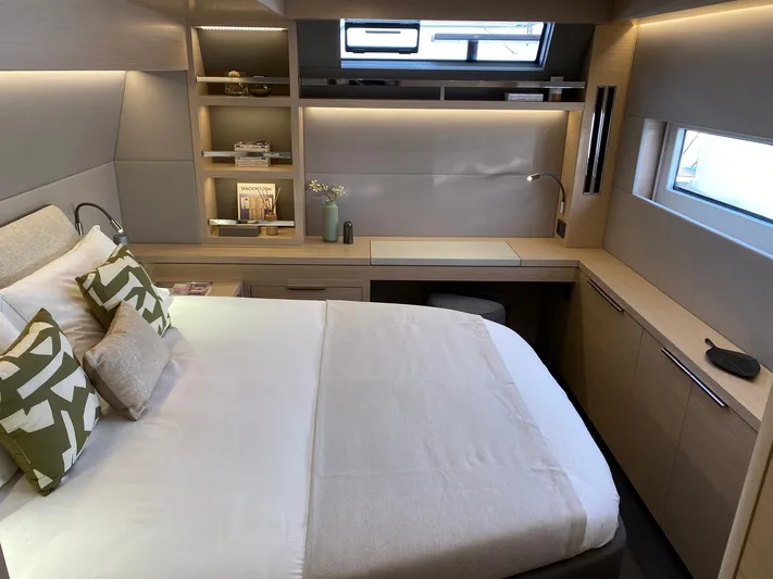Slow Down Yacht Photos Pics Luxurious 2023 Lagoon 55 yacht bedroom with modern design and elegant furnishings.