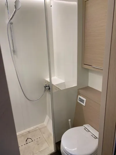 Slow Down Yacht Photos Pics Modern bathroom in 2023 Lagoon 55 yacht with shower and toilet.