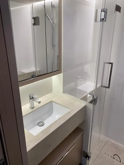 Slow Down Yacht Photos Pics Modern bathroom in 2023 Lagoon 55 yacht with sleek sink and glass shower.