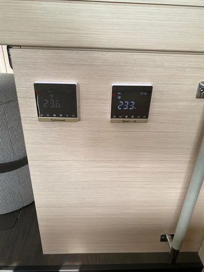 Slow Down Yacht Photos Pics Digital thermostats on a 2023 Lagoon 55 yacht interior panel.