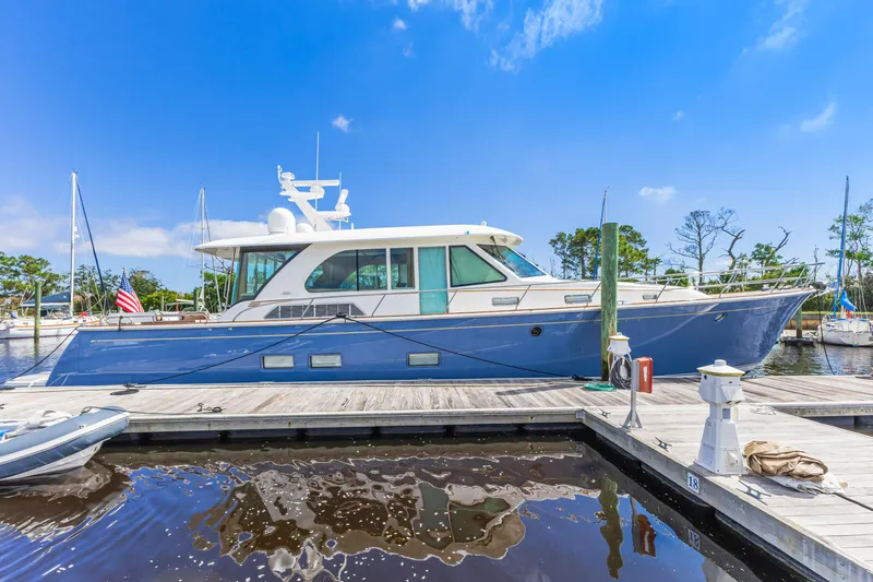 Sandcrab Yacht Photos Pics 2018 Sabre 66 Dirigo yacht docked at marina under clear blue sky.
