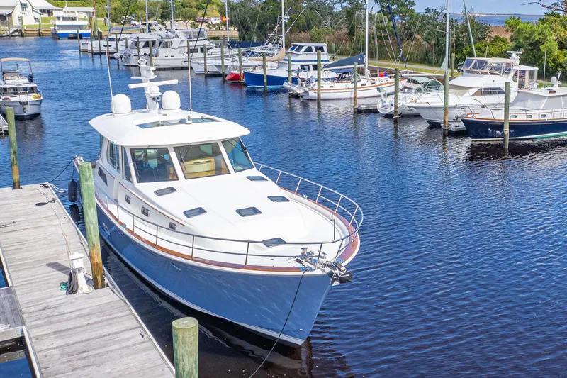 Sandcrab Yacht Photos Pics 2018 Sabre 66 Dirigo yacht docked in a marina, surrounded by other boats.