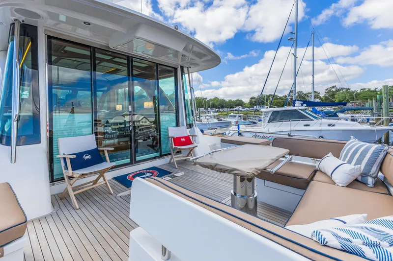 Sandcrab Yacht Photos Pics Luxurious 2018 Sabre 66 Dirigo yacht deck with seating and marina view.