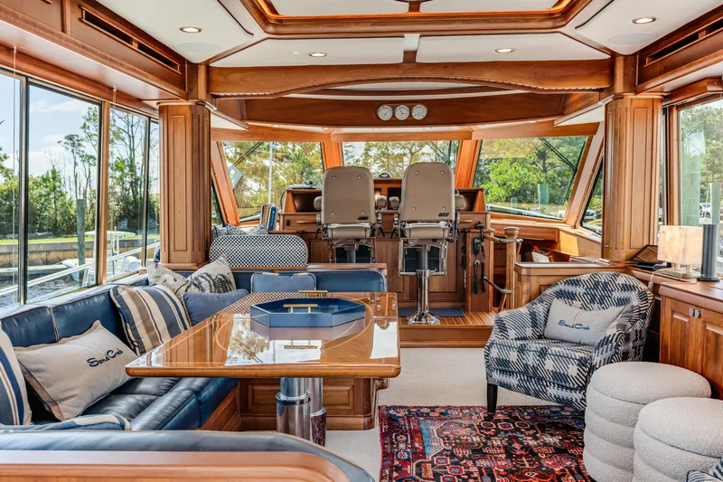 Sandcrab Yacht Photos Pics Luxurious interior of 2018 Sabre 66 Dirigo yacht with elegant seating and helm station.