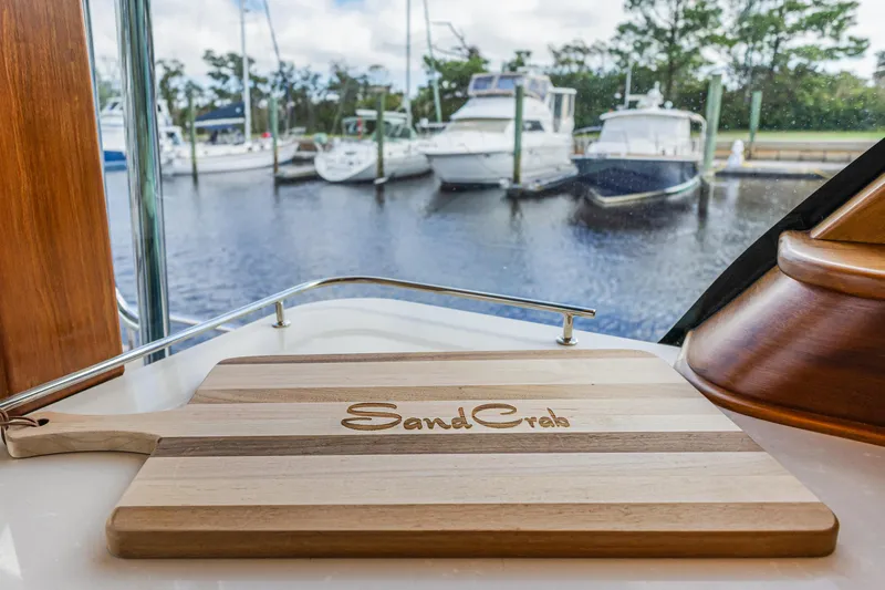 Sandcrab Yacht Photos Pics Cutting board on Sabre 66 Dirigo yacht, 2018 model, with marina view in the background.