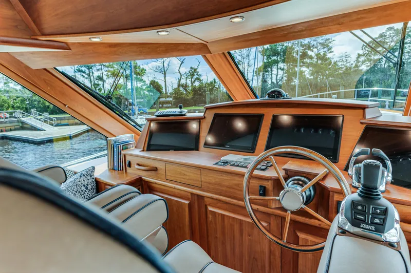 Sandcrab Yacht Photos Pics Luxurious 2018 Sabre 66 Dirigo yacht interior with wooden helm and modern navigation equipment.