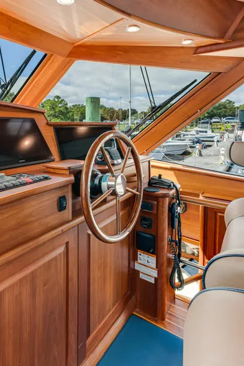 Sandcrab Yacht Photos Pics Interior of 2018 Sabre 66 Dirigo yacht with wooden helm and steering wheel.