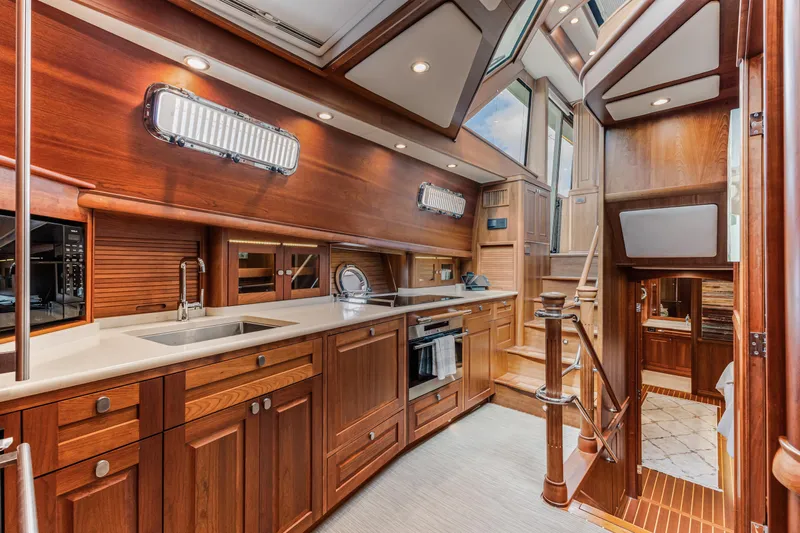 Sandcrab Yacht Photos Pics Luxurious wooden interior of 2018 Sabre 66 Dirigo yacht kitchen.
