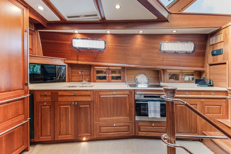 Sandcrab Yacht Photos Pics Luxurious 2018 Sabre 66 Dirigo yacht interior with elegant wooden cabinetry and modern kitchen amenities.