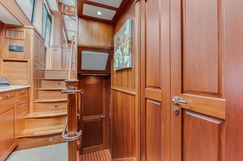 Sandcrab Yacht Photos Pics Interior of 2018 Sabre 66 Dirigo yacht with elegant wooden paneling and staircase.