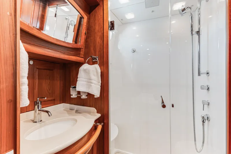Sandcrab Yacht Photos Pics Luxurious bathroom in 2018 Sabre 66 Dirigo yacht with wood accents and modern fixtures.