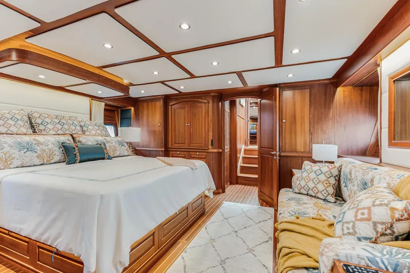 Sandcrab Yacht Photos Pics Luxurious interior of 2018 Sabre 66 Dirigo yacht with elegant wood paneling and plush bedding.