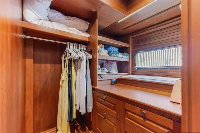 Sandcrab Yacht Photos Pics Spacious wooden closet in 2018 Sabre 66 Dirigo yacht with shelves and hanging clothes.