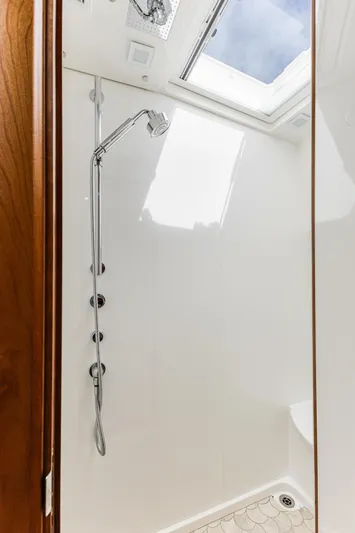 Sandcrab Yacht Photos Pics Shower area in 2018 Sabre 66 Dirigo yacht with skylight and modern fixtures.