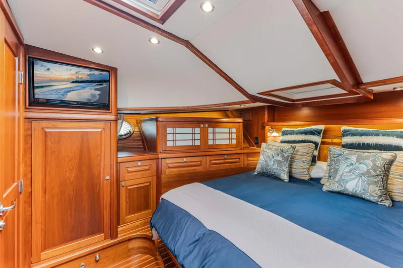 Sandcrab Yacht Photos Pics Luxurious cabin interior of 2018 Sabre 66 Dirigo yacht with wood finish and cozy bedding.