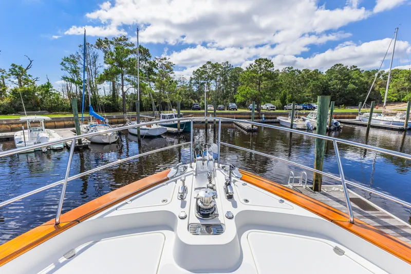 Sandcrab Yacht Photos Pics Bow view of 2018 Sabre 66 Dirigo yacht docked in a serene marina.