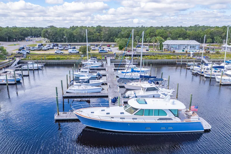 Sandcrab Yacht Photos Pics 2018 Sabre 66 Dirigo yacht docked at a marina with other boats.