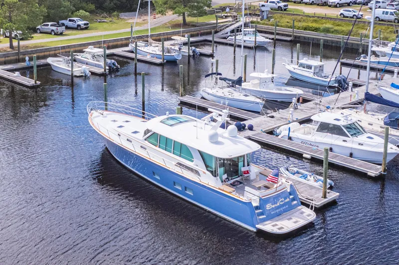 Sandcrab Yacht Photos Pics 2018 Sabre 66 Dirigo yacht docked in a marina, surrounded by other boats.