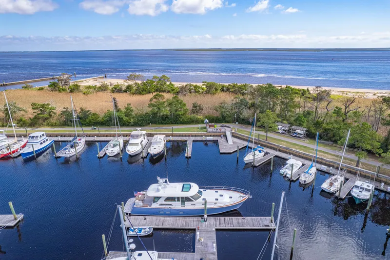 Sandcrab Yacht Photos Pics 2018 Sabre 66 Dirigo yacht docked in a scenic marina with ocean view.