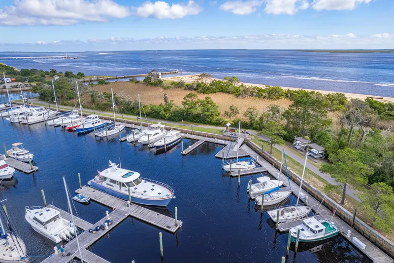 Sandcrab Yacht Photos Pics Marina with boats, featuring a 2018 Sabre 66 Dirigo, under a clear blue sky.