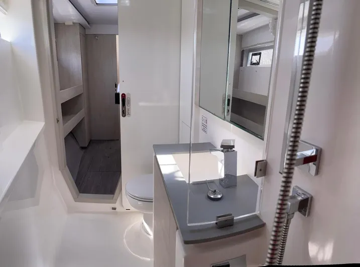 Seventeen Yacht Photos Pics Modern bathroom interior in a 2020 Leopard 50 yacht, featuring sleek fixtures and ample lighting.