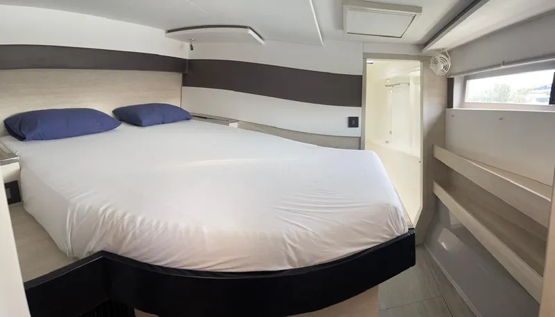 Seventeen Yacht Photos Pics Modern bedroom interior in a 2020 Leopard 50 yacht with a large bed and natural light.