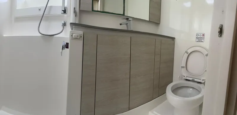 Seventeen Yacht Photos Pics Modern bathroom in a 2020 Leopard 50 yacht with toilet, sink, and shower.