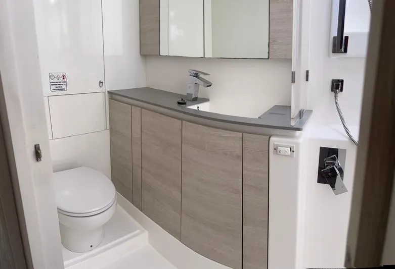 Seventeen Yacht Photos Pics Modern bathroom in a 2020 Leopard 50 yacht with sleek cabinetry and fixtures.