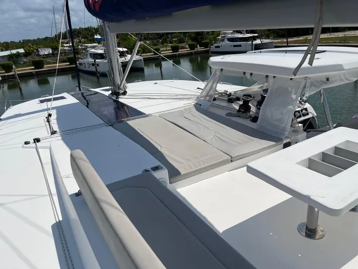 Seventeen Yacht Photos Pics Leopard 50 catamaran 2020 model, spacious deck with seating and sunbathing area, docked at marina.