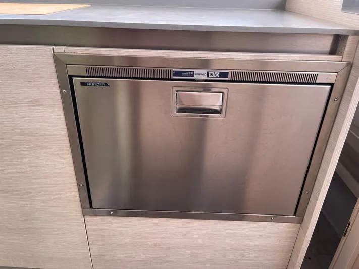 Seventeen Yacht Photos Pics Built-in stainless steel dishwasher, Leopard 50 model, 2020, installed in modern kitchen cabinetry.