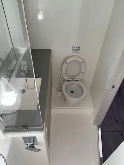 Seventeen Yacht Photos Pics Modern bathroom in a 2020 Leopard 50 yacht with toilet and sink.