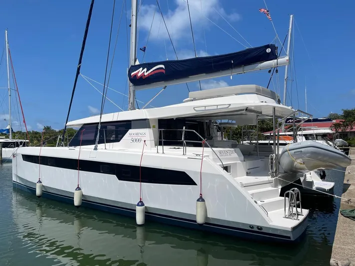 Seventeen Yacht Photos Pics 2020 Leopard 50 catamaran docked at marina with blue sky background.