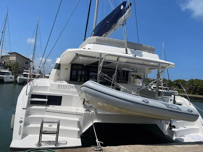 Seventeen Yacht Photos Pics Leopard 50 catamaran yacht docked with dinghy, 2020 model.