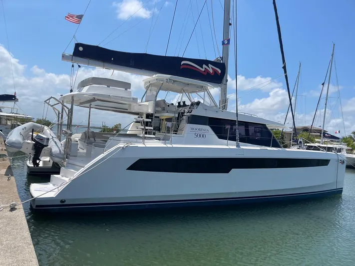 Seventeen Yacht Photos Pics 2020 Leopard 50 catamaran docked at a marina on a sunny day.