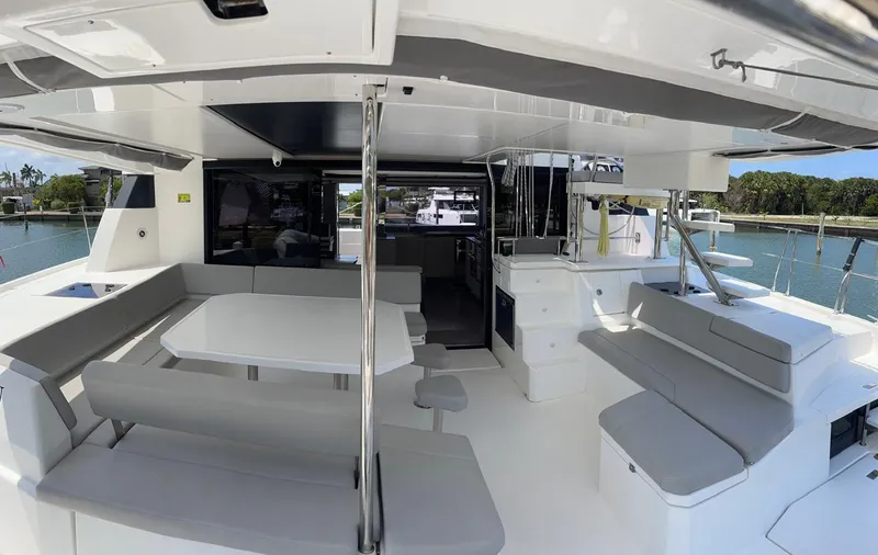 Seventeen Yacht Photos Pics Spacious deck area of a 2020 Leopard 50 catamaran with seating and dining table.